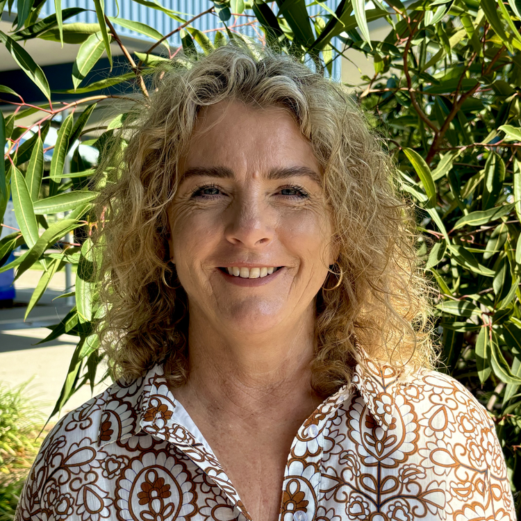 Portrait photo of school principal smiling.